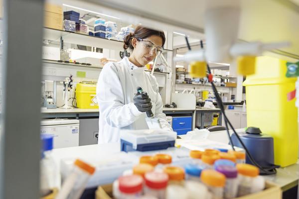 Scientist in white coat in a lab